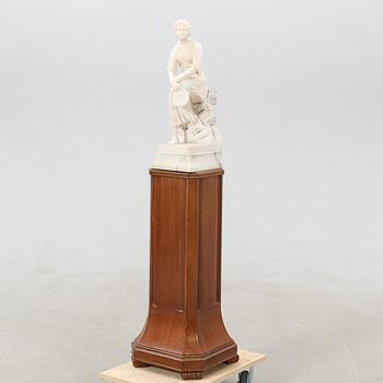 Decorative sculpture Seated woman with tambourine.