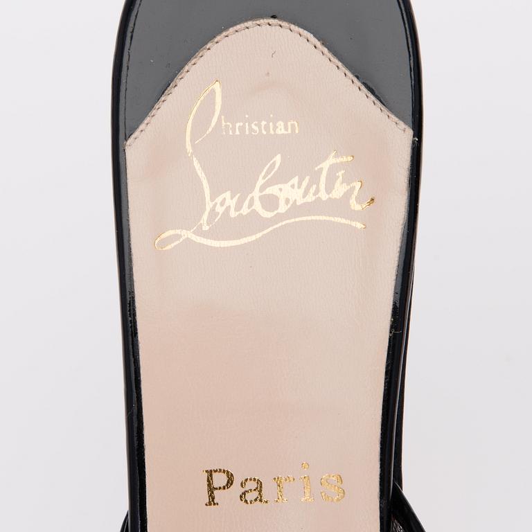 A PAIR OF CHRISTIAN LOUBOUTIN LACE MESH AND LEATHER MULES, size 41.5.