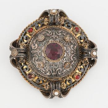 Silver and garnet brooch.