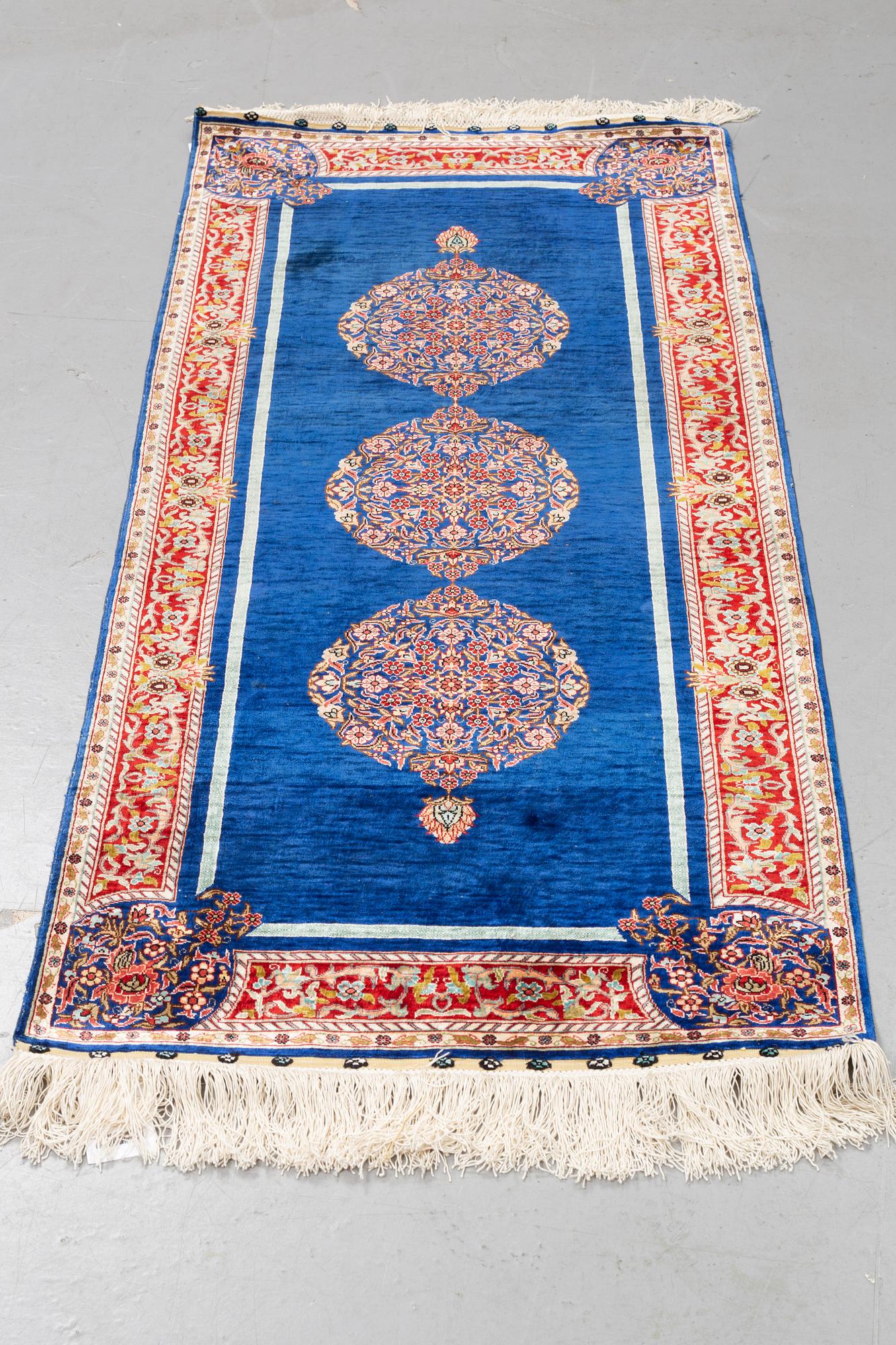A rug, silk Hereke, ca 143 x 63,5 cm.