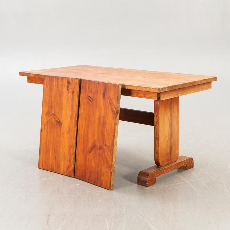 A 1940s pine dining table.