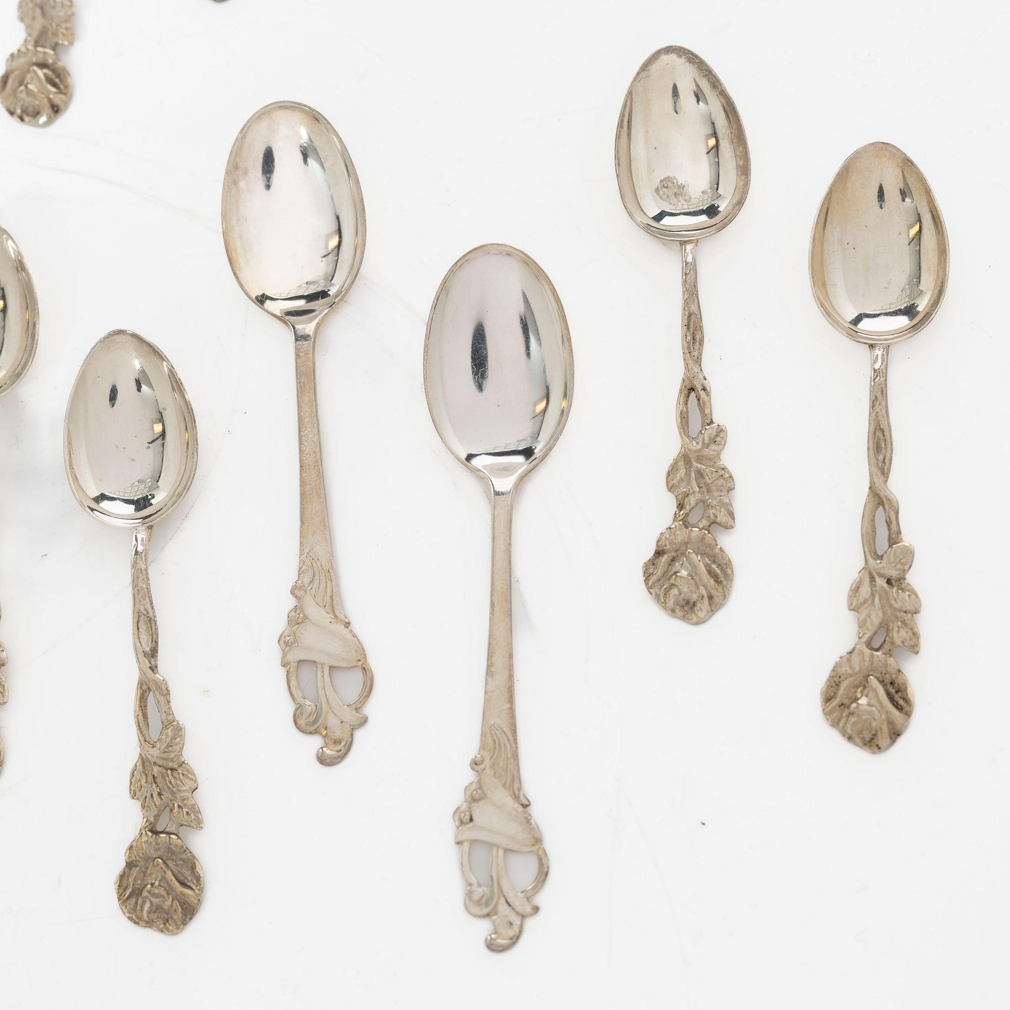 A pair of beakers, two napkin rings, and 17 pieces of cutlery, silver.