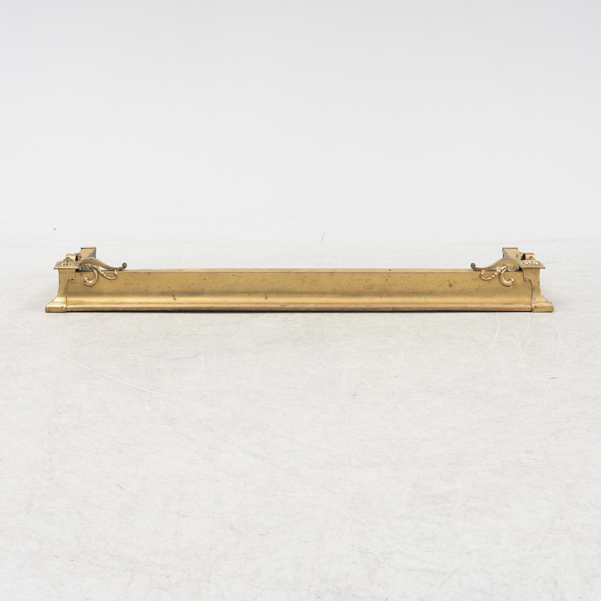 A brass fire guard, around 1900.