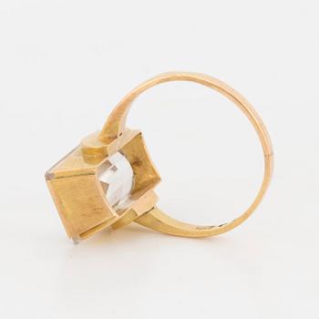 A ring set with a step-cut quartz.