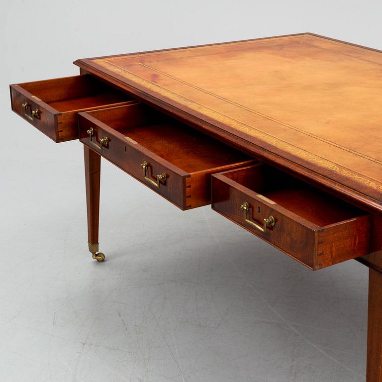 A contemporary mahogany and leather partners desk in the George III style.
