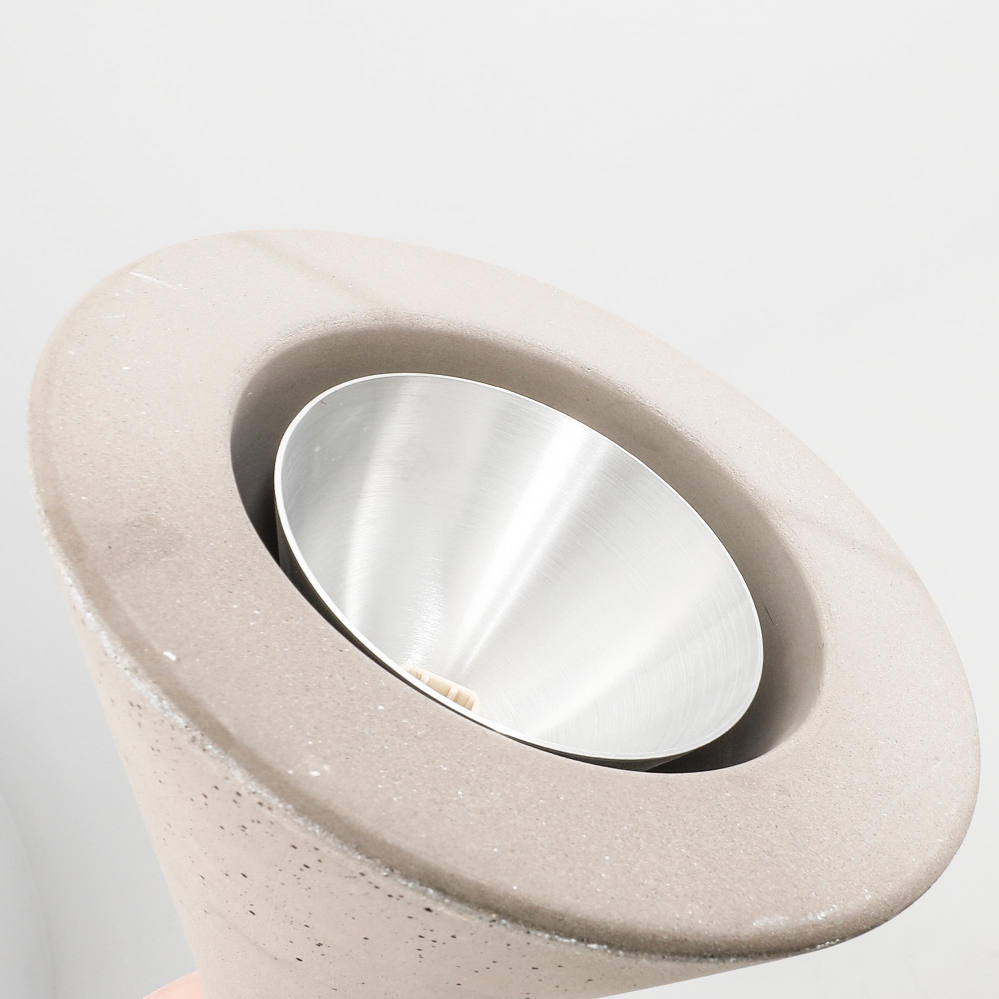 A set of four Aplomb mini" concrete ceiling pendants from Lucidi & Pever.