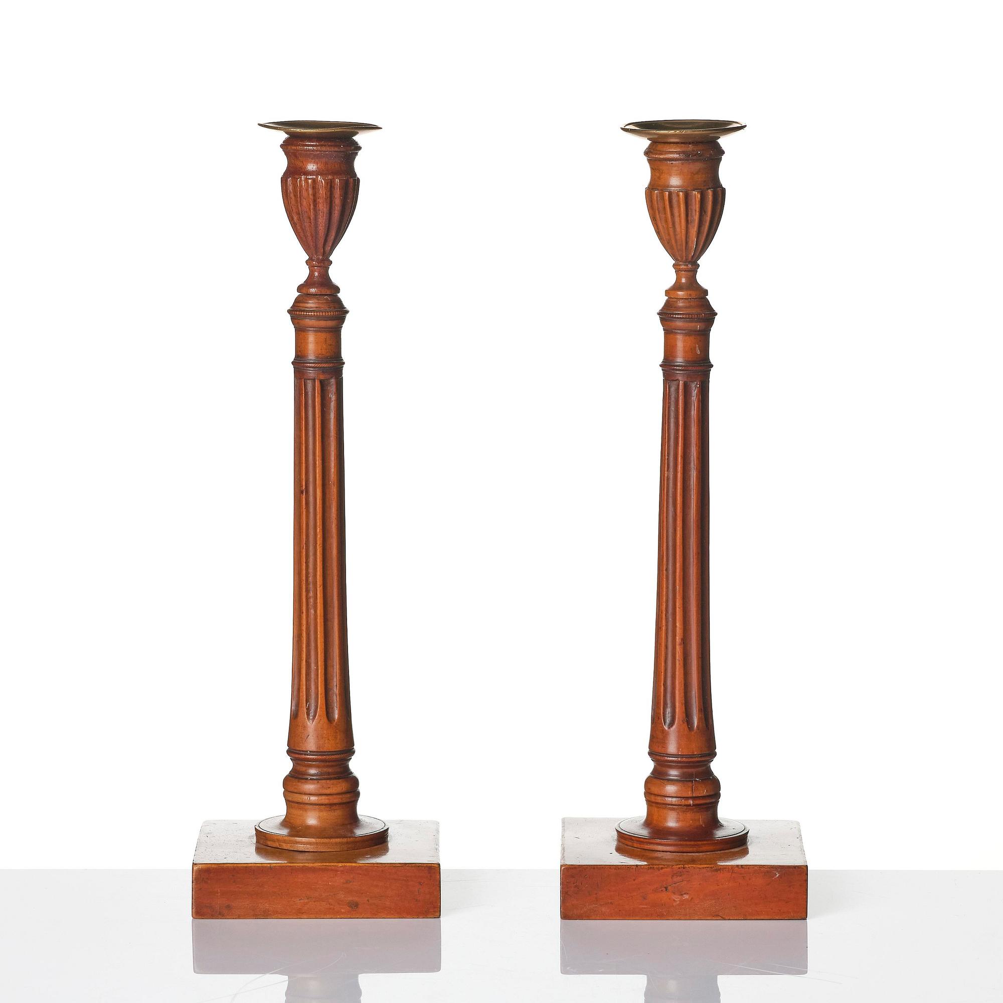 A pair of George III mahogany candlesticks, circa 1800.