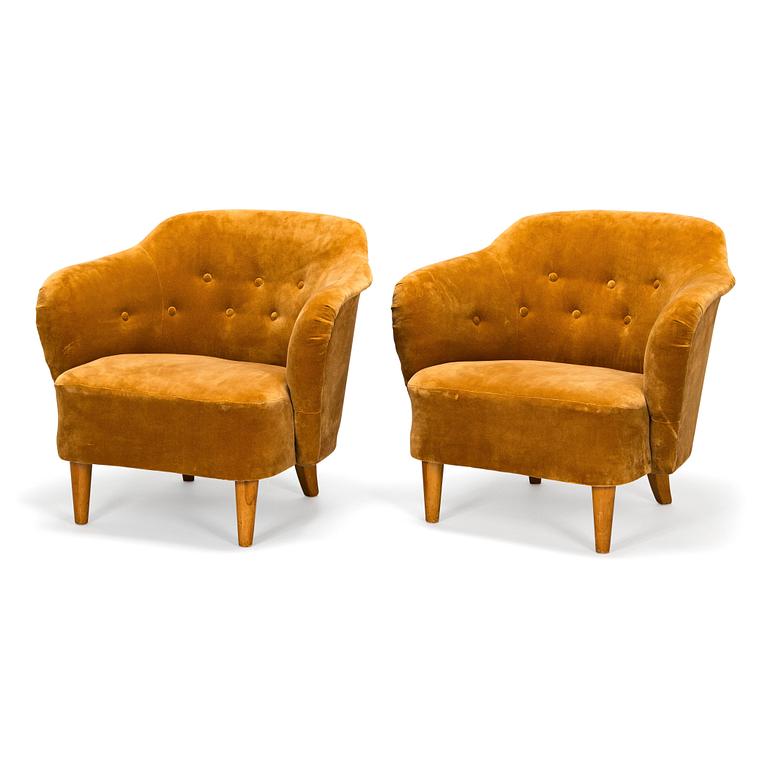 A pair of mid-20th-century armchairs.