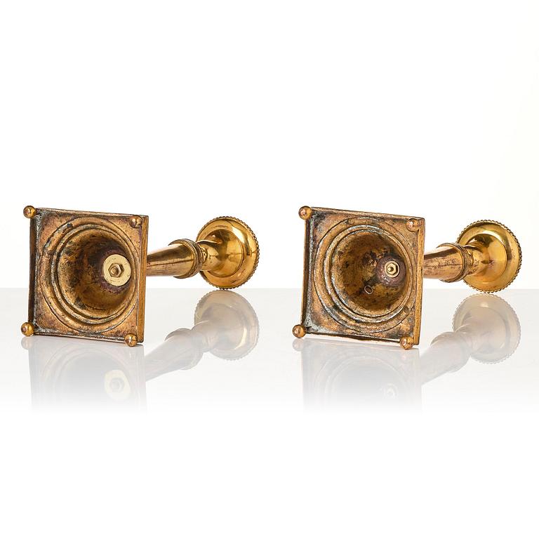 A pair of late George III gilt-copper candlesticks, early 19th century.
