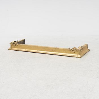 A brass fire guard, around 1900.