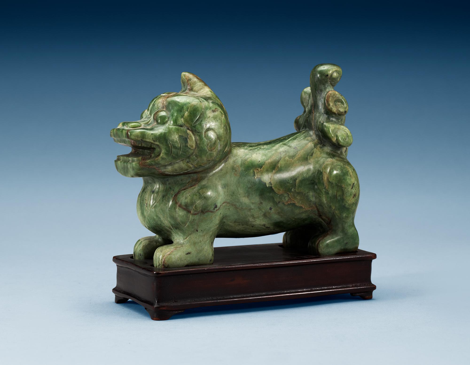 A nephrite figure of a Buddhist Lion, late Qing dynasty.