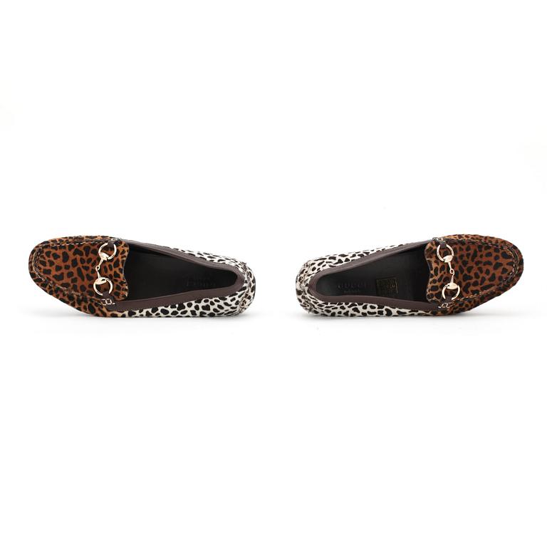 GUCCI, a pair of leopard patterned loafers.