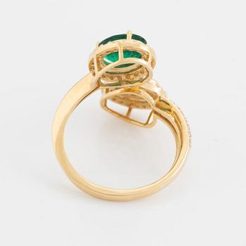 Emerald and diamond cross over ring.