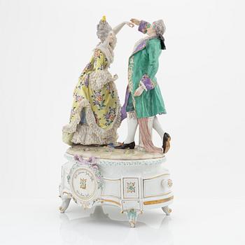 A rococo style porcelain figurine from the early 20th century.