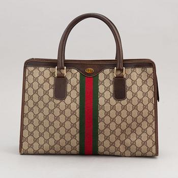 Gucci, a canvas handbag.