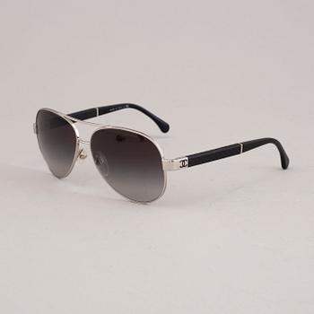 Chanel black pilot summer glasses.