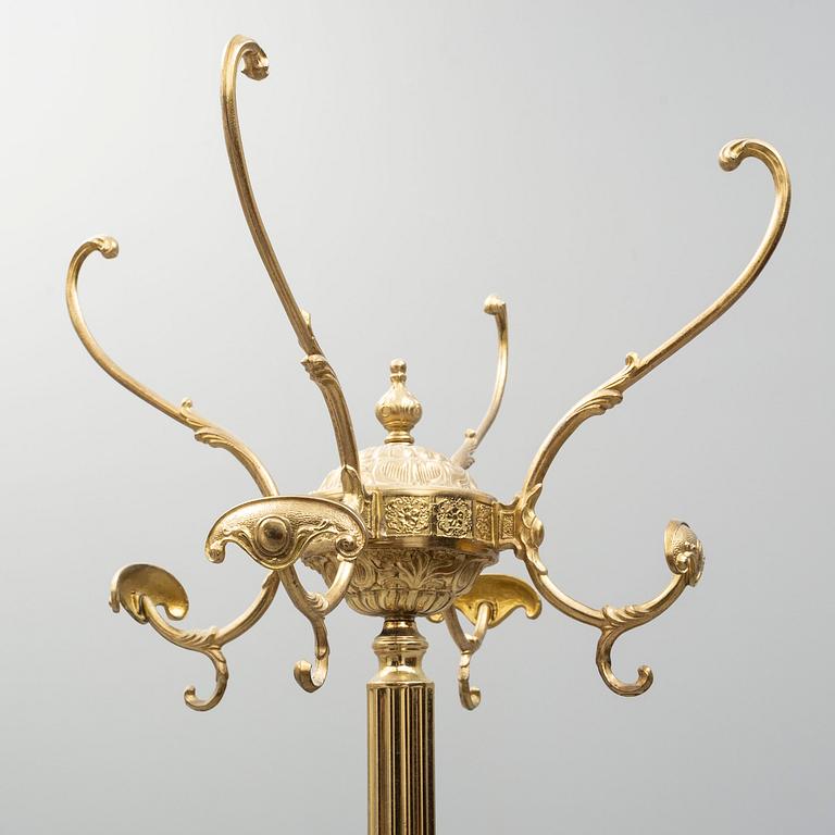 a brass coat hanger from the late 20th century.