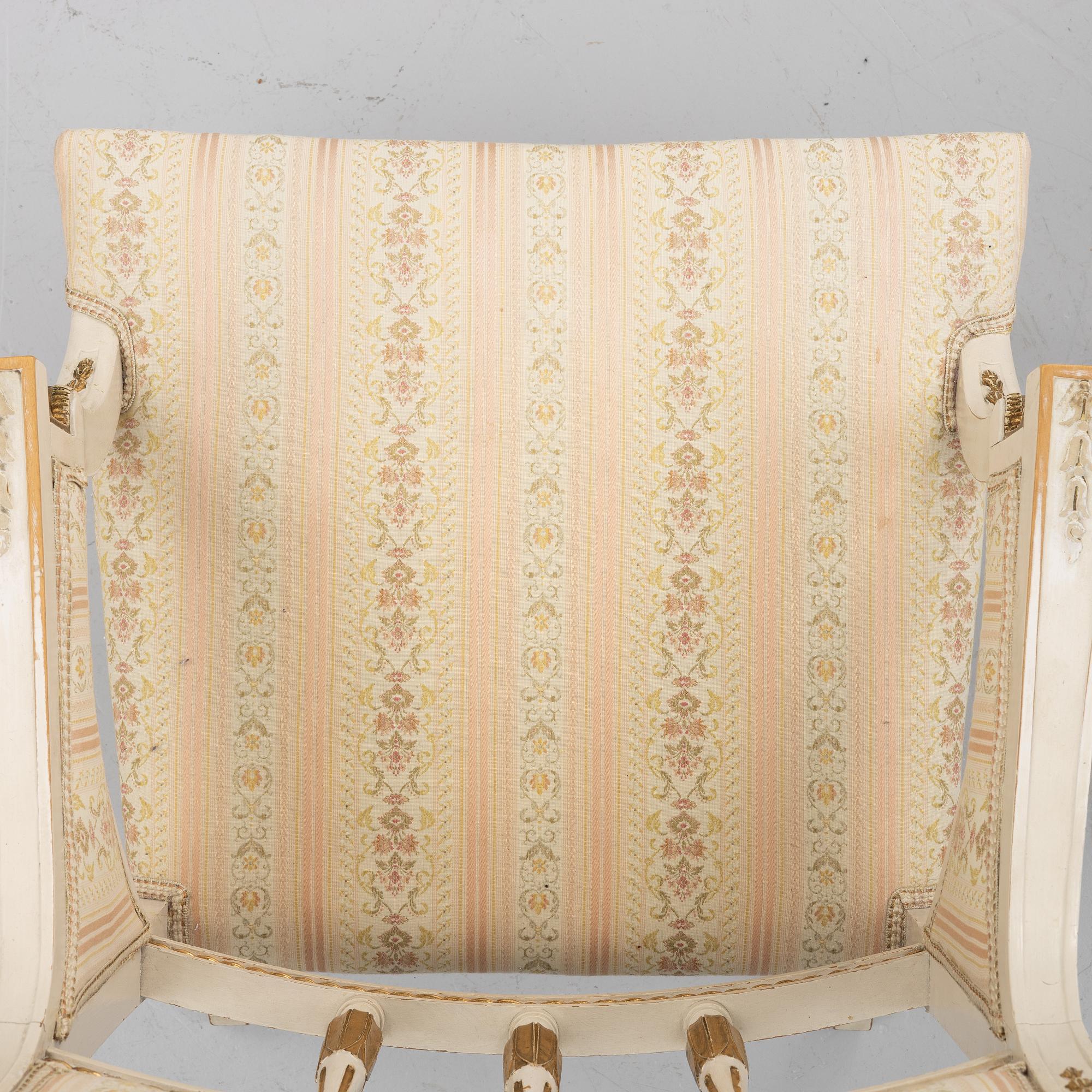 A pair of chairs and an armchair, late Gustavian style, early 20th century.