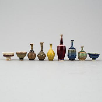 A mixed lot of glazed Höganäs ceramic miniture vases and bowls, four signed by John Andersson.