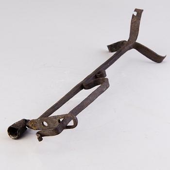 A 18th century wrought iron rush light and candle holder.