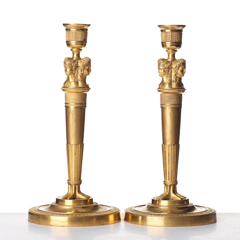 A pair of French Empire early 19th century gilt bronze candlesticks.