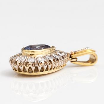 An 18K gold penadant with brilliant cut diamonds ca. 1.45 ct in total and a sapphire.