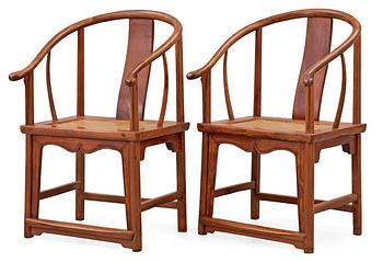 A pair of hardwood horseshoeback armchairs, Qing dynasty.
