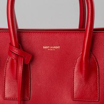 Saint Laurent, a red leather 'Sac du Jour Small' bag.