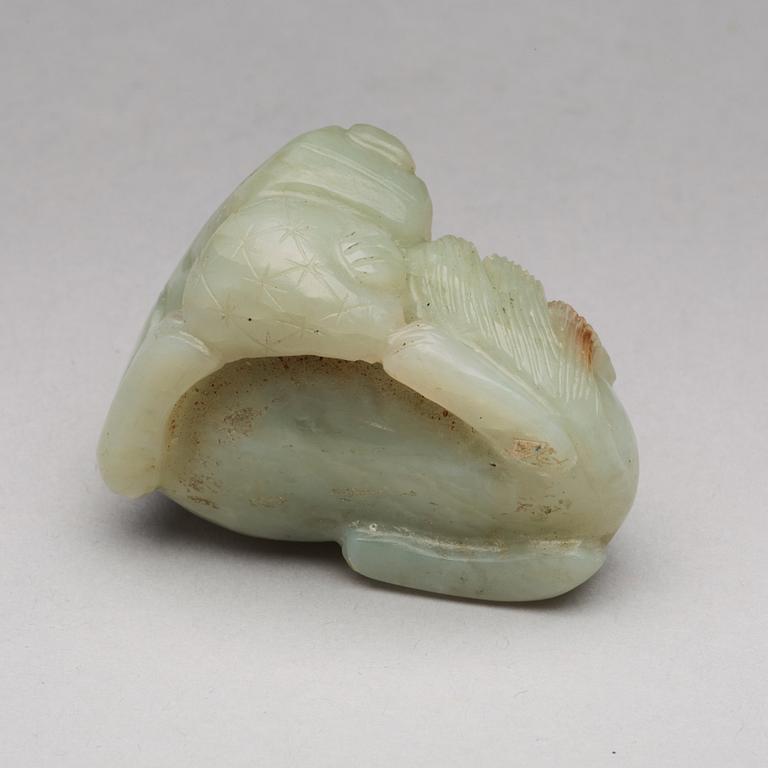 A nephrite figure of a reclining mythical beast, late Qing dynasty.