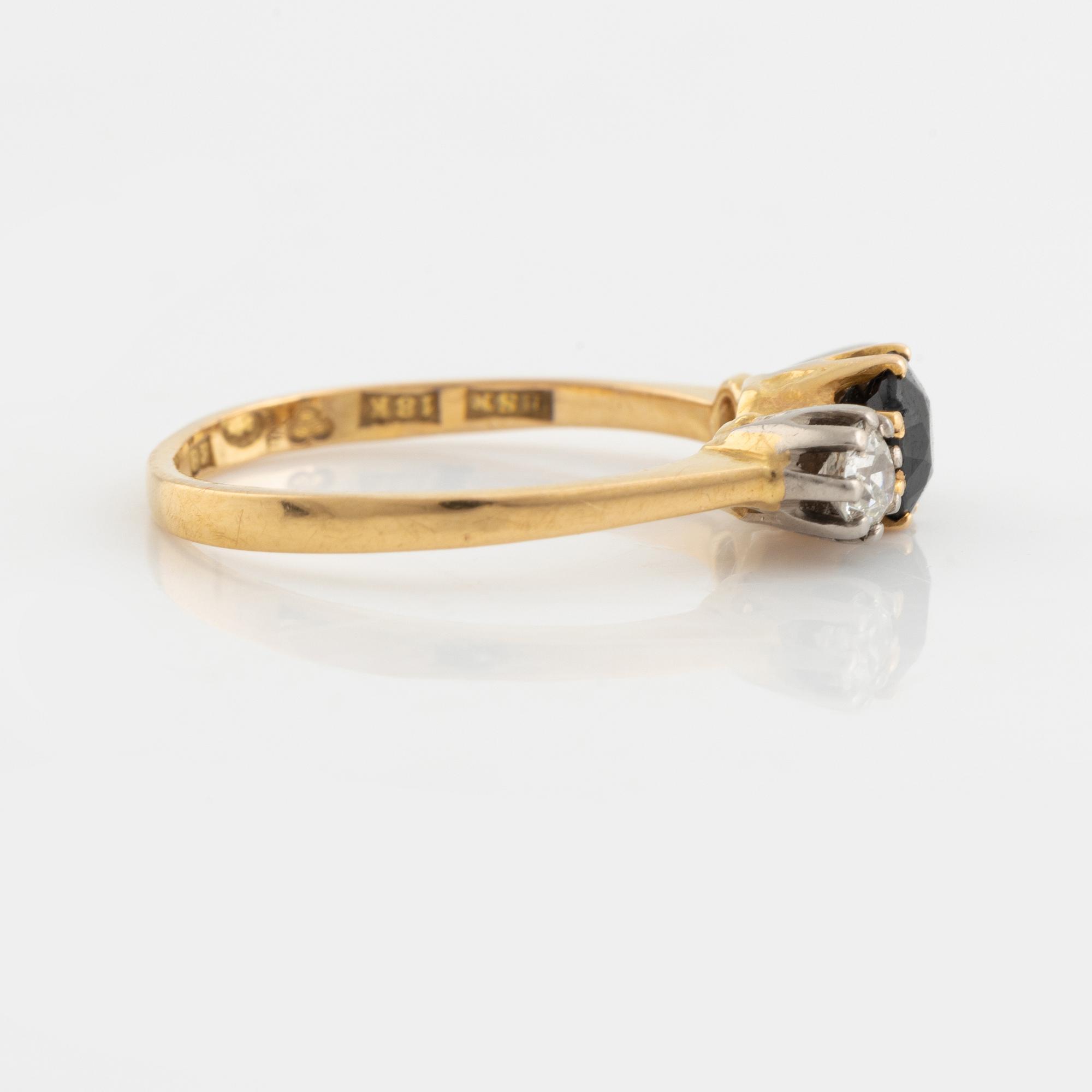 An 18K gold ring set with a sapphire and old-cut diamonds.