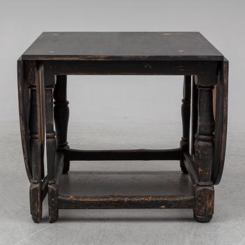 A painted pine Baroque style gate leg table, 20th Century with older parts.