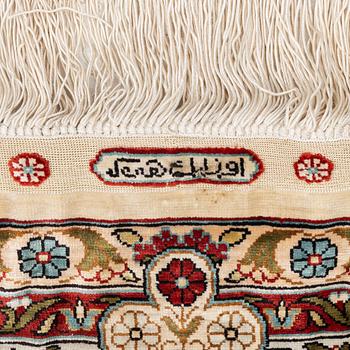 A semi-antique silk Hereke rug, West Anatolia, c. 180 x 121 cm.