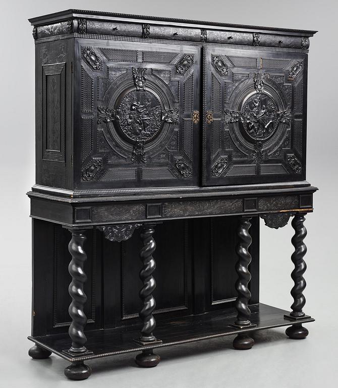 A Louis XIV and Louis XIV-style carved ebony, ivory and tortoiseshell-inlaid cabinet on stand, 17th and 19th century.