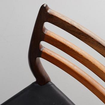 Niles Otto Møller, a rosewood veneered table with four chairs, JL Møller, Denmark, 1950's/60's.