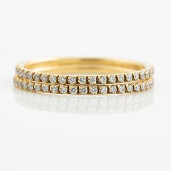 Rings, Georg Jensen. a pair, "Signature", 18K gold with brilliant-cut diamonds.