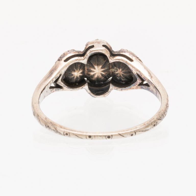 An 18K white gold ring set with rose cut diamonds.