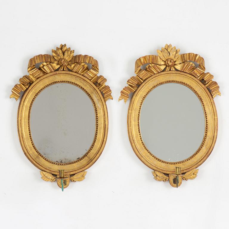 A pair of one-light Gustavian-style giltwood girandole mirrors, late 18th c /resp circa 1900.