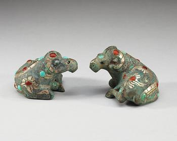 A pair of archaistic bronze figures of rams.