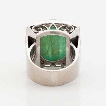 An 18K white gold ring set with a cabochon-cut emerald and round- and eight-cut diamonds.