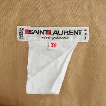 YVES SAINT LAURENT,a two-piece beige cotton dress consisting of jacket and pants, from the Safari collection s/s 1968.