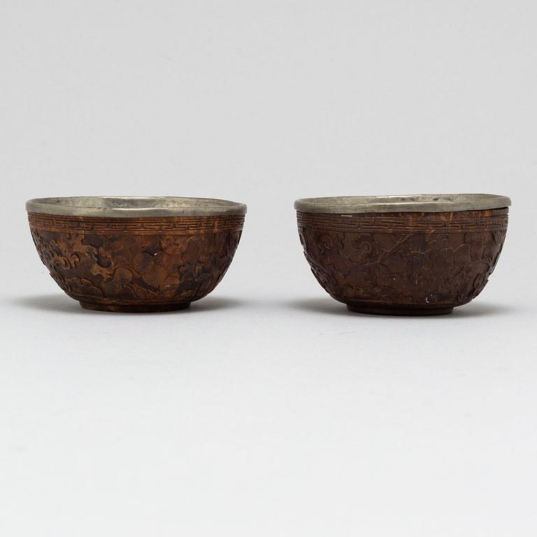 A pair of wooden bowls with pewter inlays, Qing dynasty, late 19th/early 20th century.