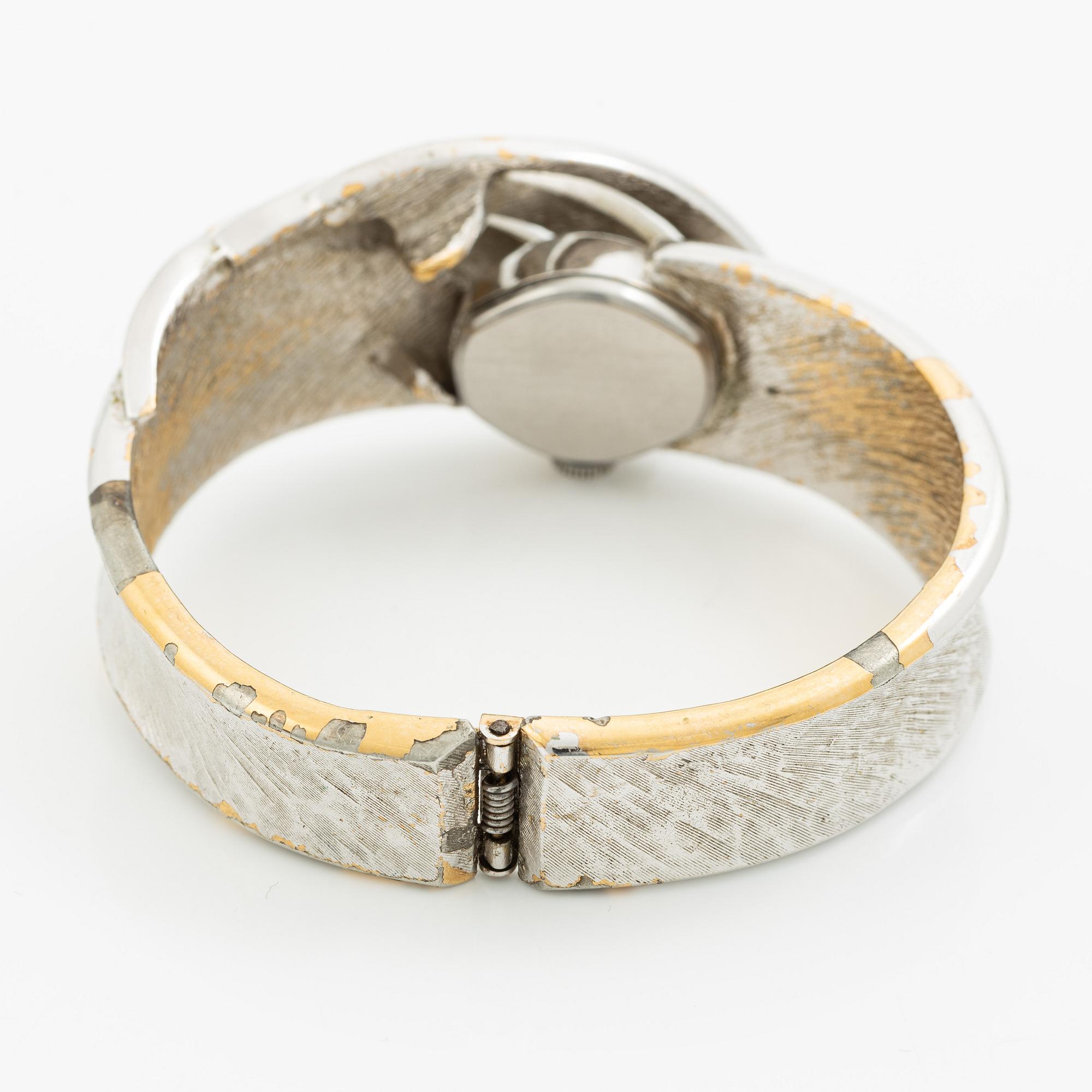 Aftonklocka/armring, Bo Dolk, 18K vitguld med briljantslipade diamanter, 1970-tal.