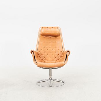 A Bruno Mathsson Jetson leather easy chair and stool later part of the 20th century.