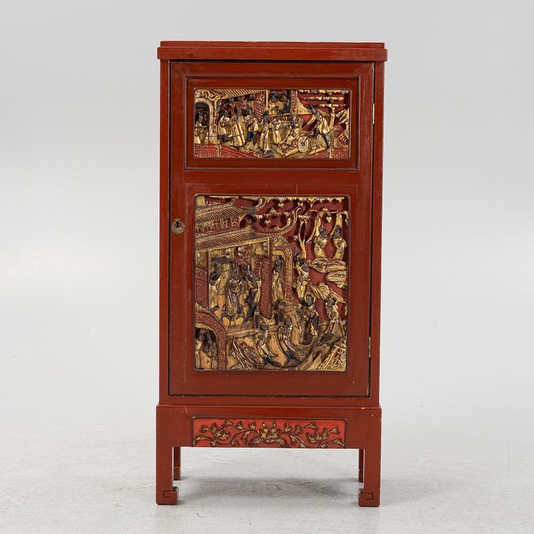 A Chinese cabinet, early 20th Century, with 19th Century carved panels.