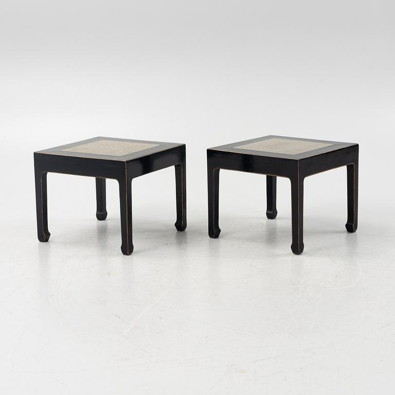 A pair of blac painted side tables with stone tops.
