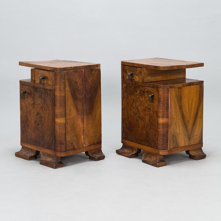 A pair of around 1930s bedside tables.