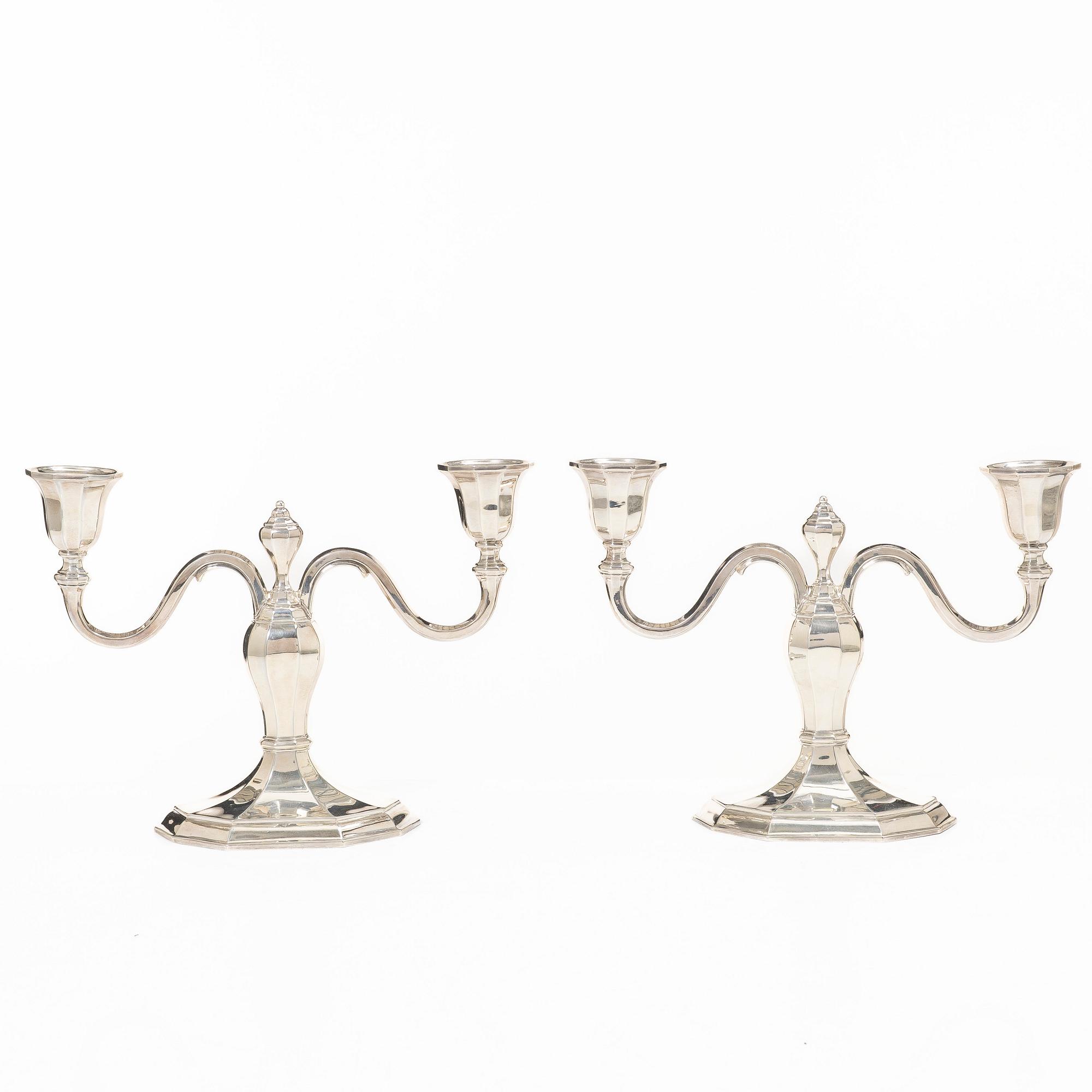 A pair of silver candelabras, with Swedish import marks, possibly mid20th century.