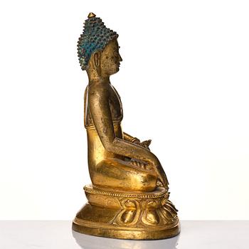 A Tibeto Chinese style gilt copper alloy figure of Buddha.