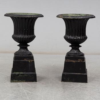 A pair of 20th century cast iron urns.