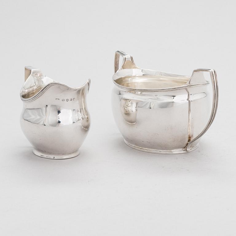 An early 19th-century, sterling silver sugar bowl, mark of Elizabeth Morley, and a cream jug, marked A.B, London 1808.